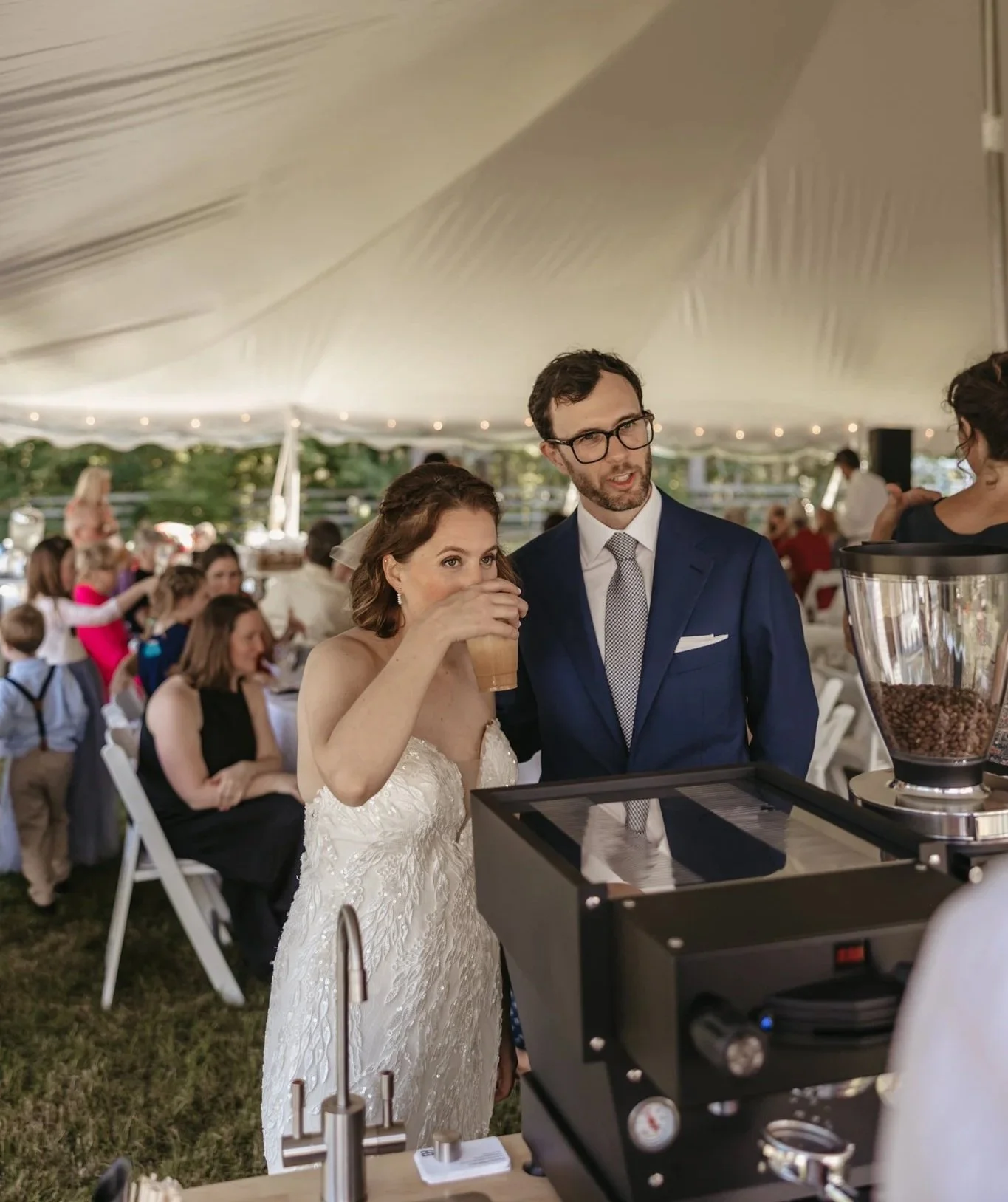 Bride and groom at a wedding reception under a white tent in Portsmouth